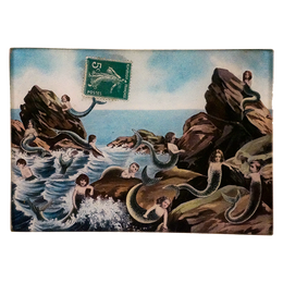 An illustration of mermaids and sea creatures on a four and a half inch ny six and a half inch glass tray.