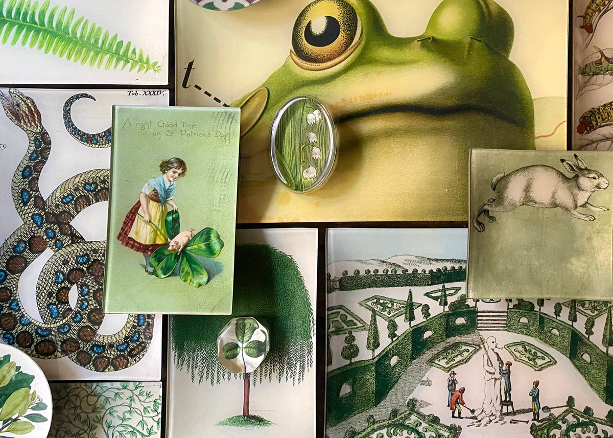Green colored glass decoupage trays on a table