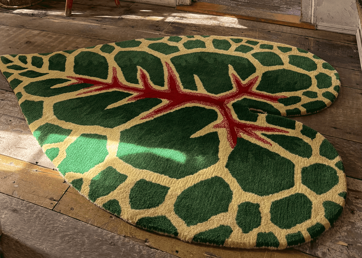 Photograph of leaf-shaped rug on a wooden floor