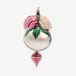 A decorative glass ornament shaped like a pear with hand-painted pink and cream roses, green leaves with gold outlines, and a red conical finial at the bottom, shown on a plain light gray background.