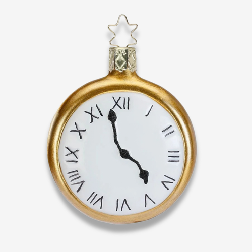 A gold-finished clock-shaped ornament with a white face, black Roman numerals, and black hands, topped with a small gold star.