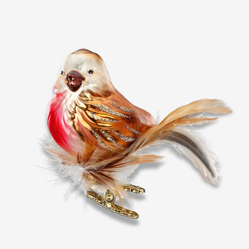 A decorative bird ornament or figurine with a cream-colored head, brown and tan body, glittery gold feather details, a bright pink-red chest, and white and brown feathers, shown on a plain light gray background.