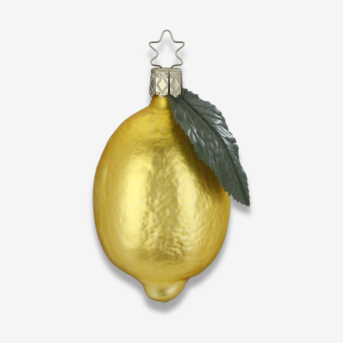 A textured gold Christmas ornament shaped like a lemon, featuring a dark green leaf and a silver metal star hanger on a light gray background.