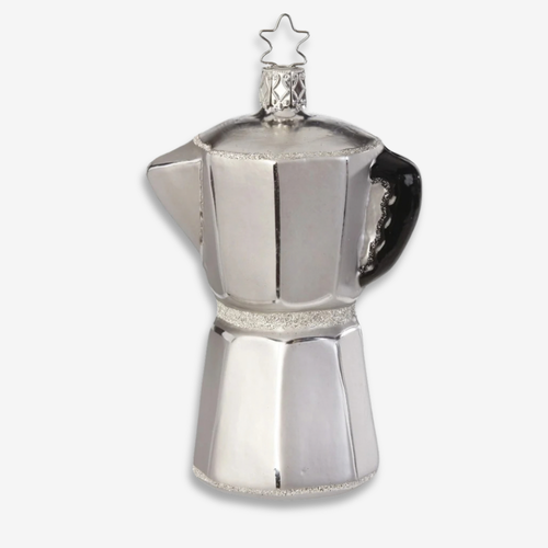 A silver moka pot holiday ornament with a glittery silver band and a black handle, topped with a star-shaped ornament on a light gray background.