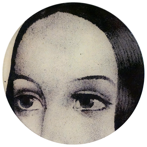 A ten inch round glass plate featuring a black and white illustration of a woman's eyes. 