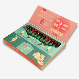 Vintage-style Christmas light set in an open illustrated box, with multiple small bulbs visible in a clear window. The box is teal, coral, and peach with retro graphics and text including 'Jewel Tone' and 'Plastic'.