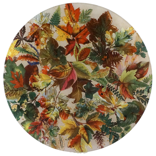 An eleven inch round glass plate featuring an all-over autumn leaf pattern in shades of orange, red, yellow, green, and brown on a light cream background.