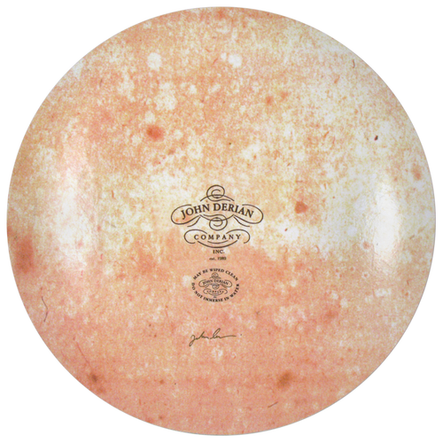The back of an 13-inch round plate  featuring the signature John Derian Company sticker and signed by John Derian. 