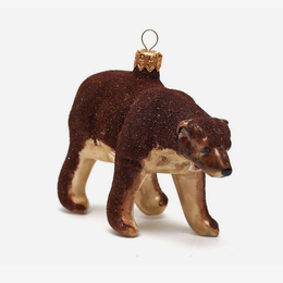 A small glittery brown polar bear Christmas ornament with a gold hanging loop, shown on a clean white background.