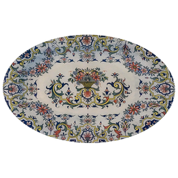 A nine inch by fourteen inch oval glass plate with a floral and geometric pattern in blue, green, and multicolor.