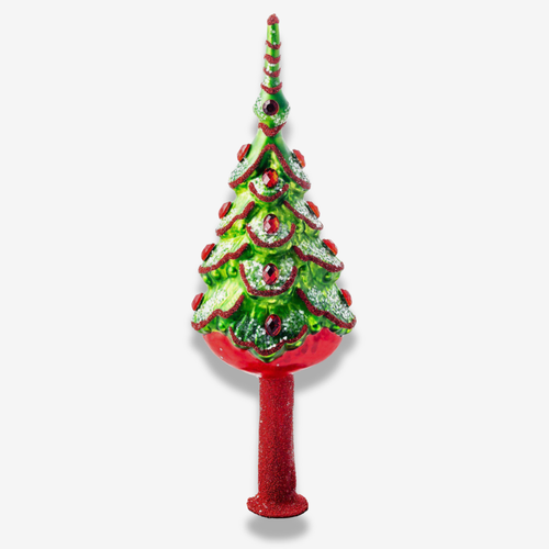 A decorative Christmas tree topper with a glittery green tree body, red scalloped trim, red ornaments, and a red base on a light gray background.