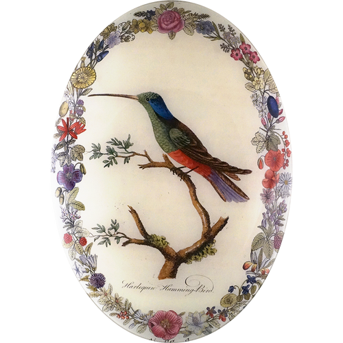 A thirteen inch by eighteen inch vertical convex oval glass plate of a hummingbird on a branch surrounded by a floral boarder. 