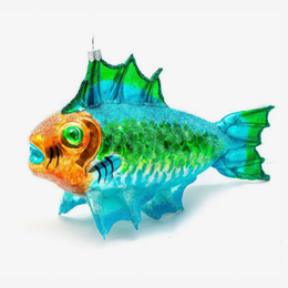 A decorative fish-shaped glass ornament with a glittery blue and green body, orange head, and bright green eye, photographed on a clean white background.