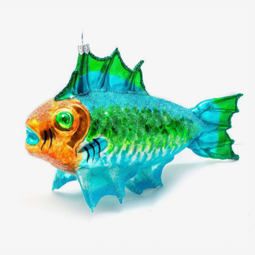 A decorative fish-shaped glass ornament with a glittery blue and green body, orange head, and bright green eye, photographed on a clean white background.