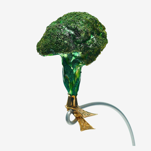 A novelty broccolini-shaped ornament made of textured green glass with a gold-tone loop and bow, shown on a plain white background.