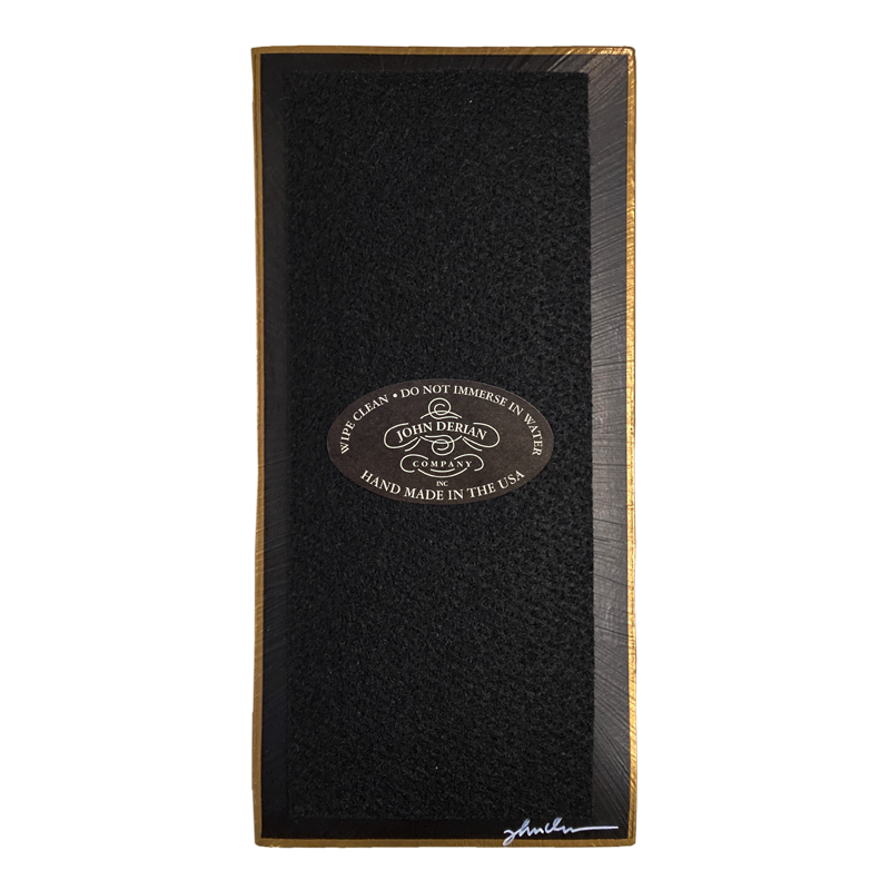 The back of a three and a half inch by seven inch that is painted black, with back felt, a gold trim and the John Derian Company logo sticker, signed by John Derian. 