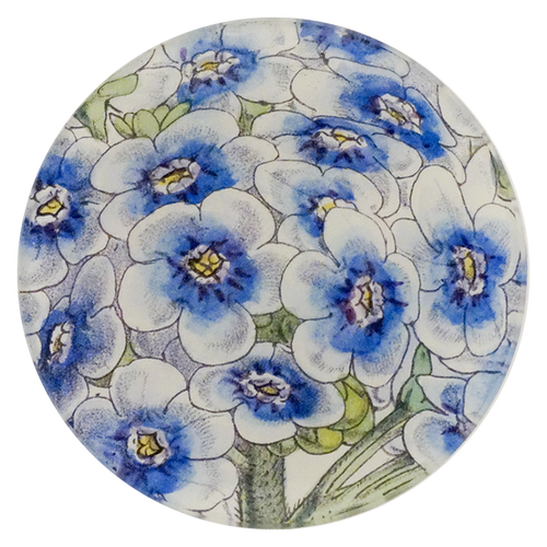A four inch round plate with blue and white floral pattern on a white background