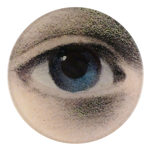 A four inch round plate featuring a close of woman's blue right eye
