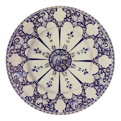 A five inch round glass plate featuring a blue and white motif with a reptile in the center