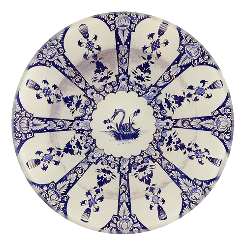 A five inch round glass plate featuring a blue and white motif with a swan in the center