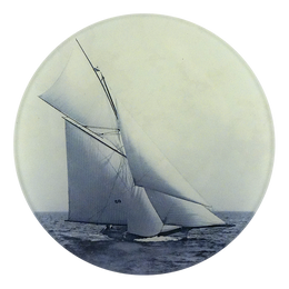A five inch round plate featuring a vintage photograph of a sailboat on the water, printed in muted blue and cream tones, isolated on a white background