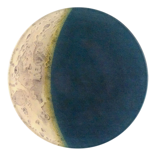 A five inch round glass plate depicting a celestial theme with a blend of light and dark areas.