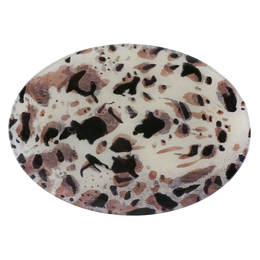 A seven inch by ten inch horizontal oval glass plate featuring black, brown, and beige chips on a cream background resembling a close up image of an egg. 