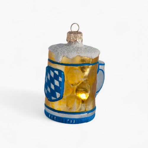 A small beer mug Christmas ornament with a blue and white Bavarian flag design, a gold hanging loop, and a warm yellow light glowing inside, set against a plain white background.