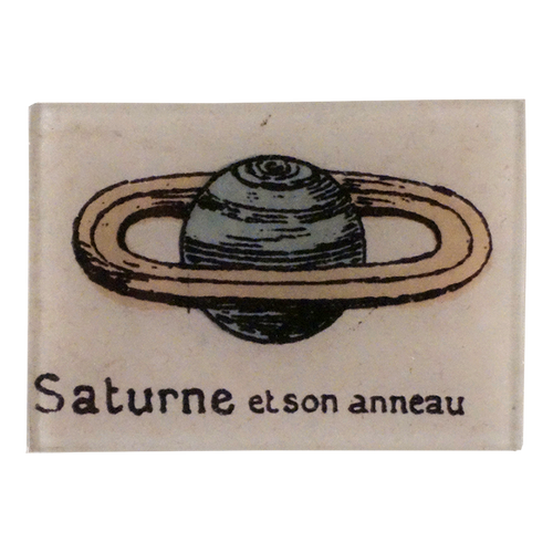 A drawing of the plante Saturn on a three and a half inch by five inch glass tray. 