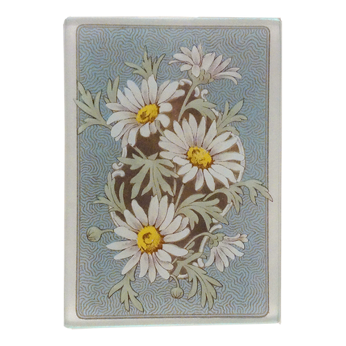 An illustration of white daisies on a green stems with a blue back ground on a three and a half inch by five inch glass tray. 