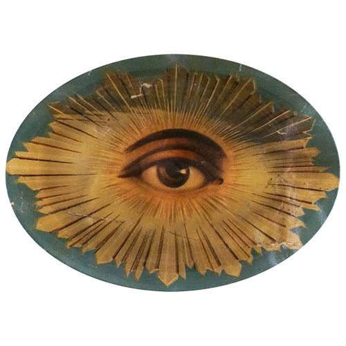 A ten inch by fourteen inch horizontal glass oval plate of an eye in the center with a predominantly blue and gold color scheme surrounding the eye. 
