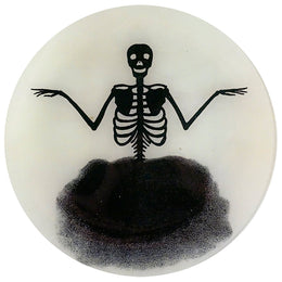 An eleven inch round glass plate featuring a skeleton design in black and white.