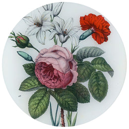 An eleven inch round glass plate with a floral design, featuring a pink rose, white lily, and red carnation.