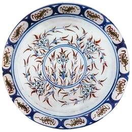 A13-inch round glass plate with blue, white, and brown floral patterns on a white background.