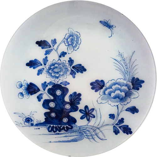 A 16-inch round glass plate featuring a blue floral drawing on a white background. 