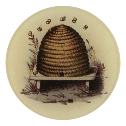 A four inch round handmade decoupage plate featuring an illustration of a bee hive with 5 small bees above 