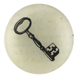 A four inch round handmade decoupage plate featuring a black key in a white background with faded font