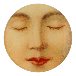 A four inch round handmade decoupage plate featuring a close up of the face of a sleeping woman