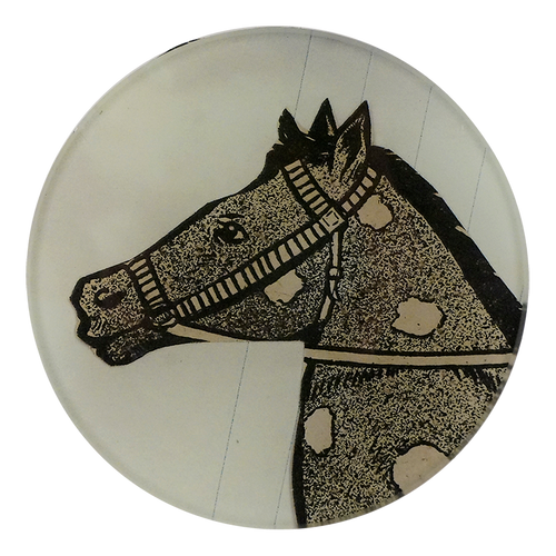 A four inch round plate featuring a black and white dotted horse design.