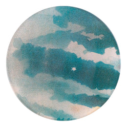 A five inch round glass plate with a celestial pattern featuring blues and greens, with a white star in the center.