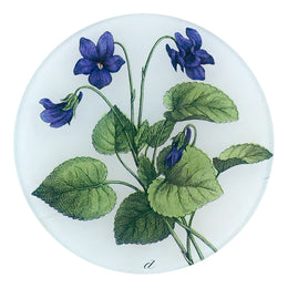 A five inch round glass plate featuring a collage of purple violets and green leaves.