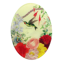A five inch by seven inch vertical oval glass plate of a hummingbird surrounded by floral designs. 