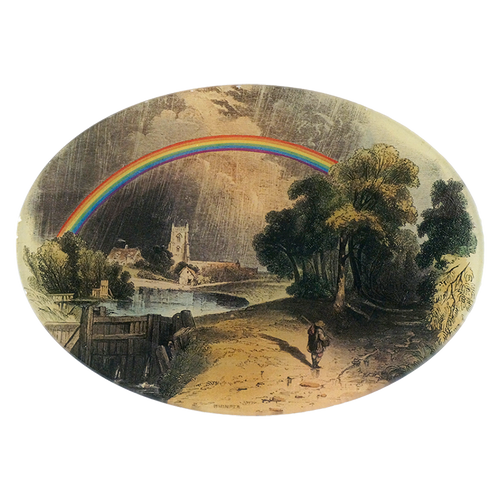 A seven inch by ten inch horizontal oval glass plate featuring a rainbow, with a person walking under the rainbow, surrounded by greenery and a building in the background.