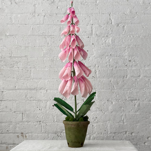 Colorful paper flowers in pot on table